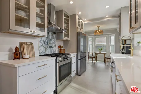 a kitchen with stainless steel appliances granite countertop a stove and a sink