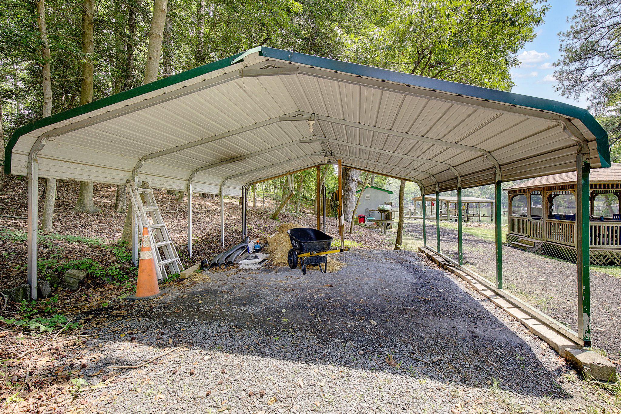 980 Apple Lane Solomons, MD 20629 - Photo 68 of 82 Spacious carport nestled in nature.