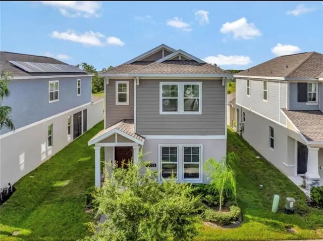 an aerial view of house with yard swimming pool and outdoor seating