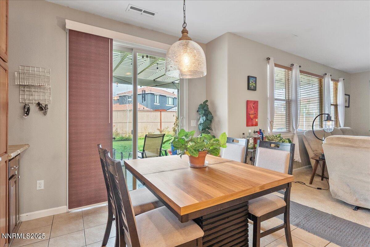 10755 Copper Lake Drive Reno, NV 89521 - Photo 12 of 40 a view of a dining room with furniture window and wooden floor