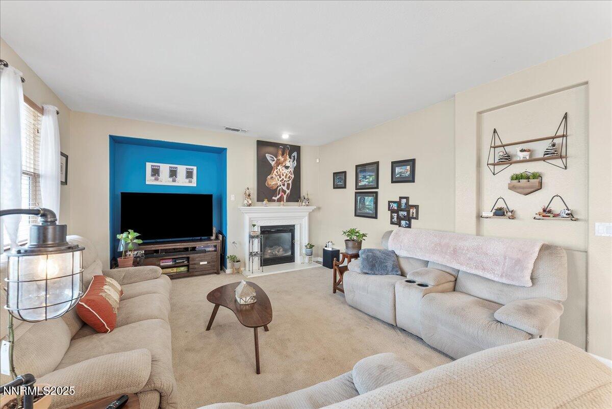 10755 Copper Lake Drive Reno, NV 89521 - Photo 14 of 40 a living room with furniture a fireplace and a flat screen tv