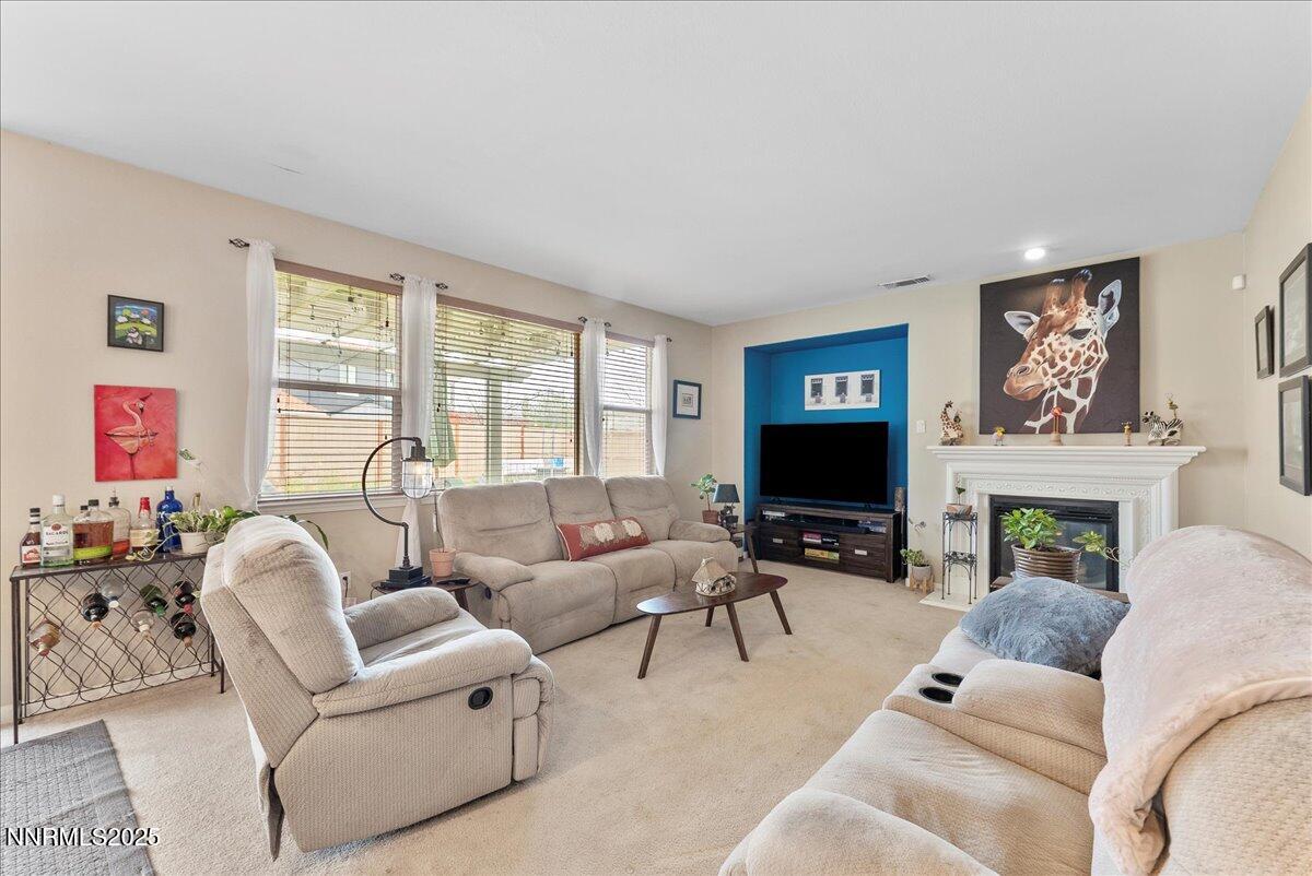 10755 Copper Lake Drive Reno, NV 89521 - Photo 15 of 40 a living room with furniture flat screen tv and a fireplace