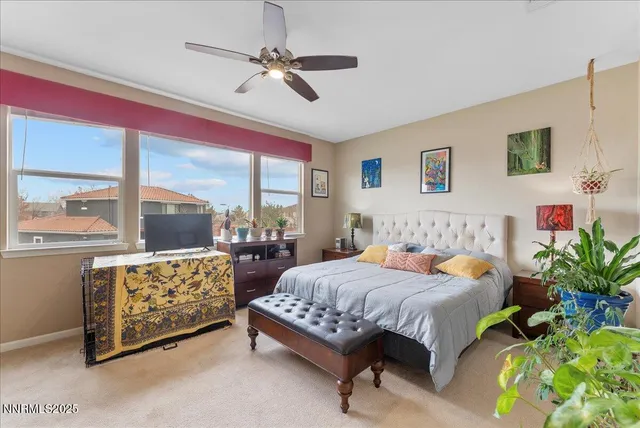 a bedroom with a bed mirror and a large window