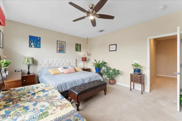 a spacious bedroom with a bed and a chandelier