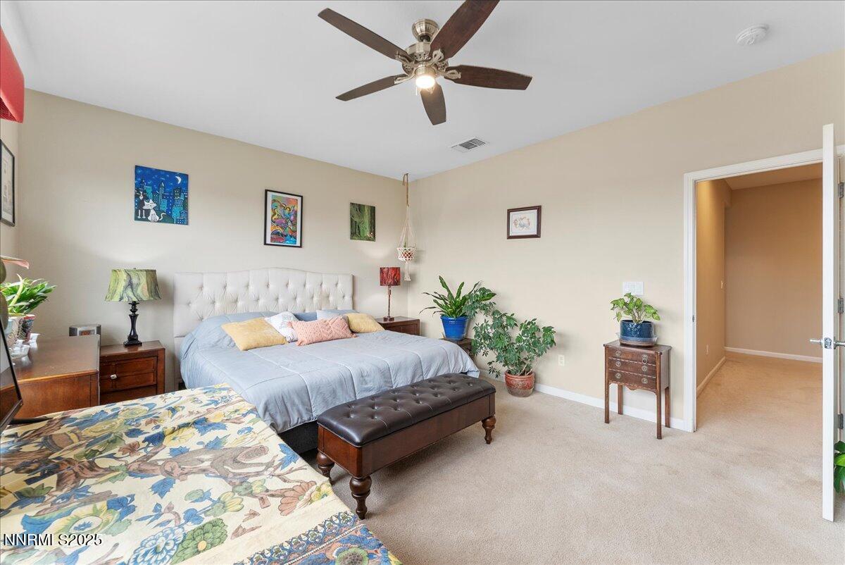 10755 Copper Lake Drive Reno, NV 89521 - Photo 17 of 40 a spacious bedroom with a bed and a chandelier