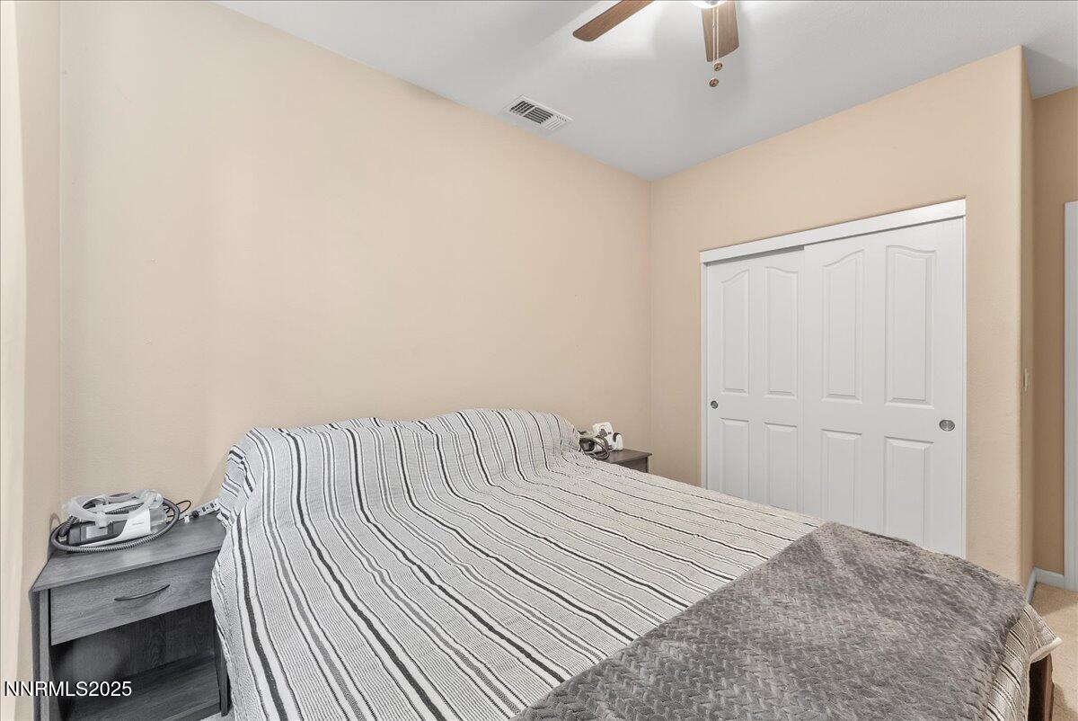 10755 Copper Lake Drive Reno, NV 89521 - Photo 21 of 40 a bedroom with a bed and wooden floor