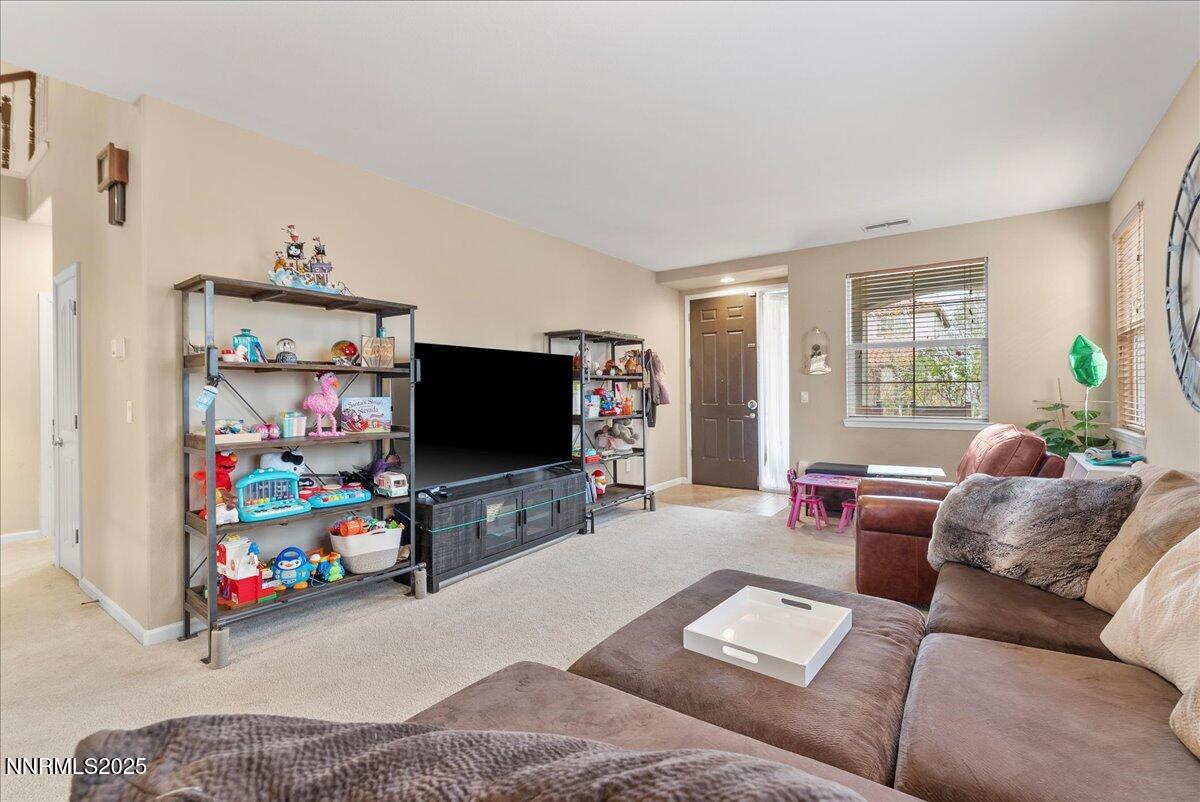 10755 Copper Lake Drive Reno, NV 89521 - Photo 3 of 40 a living room with furniture and a flat screen tv