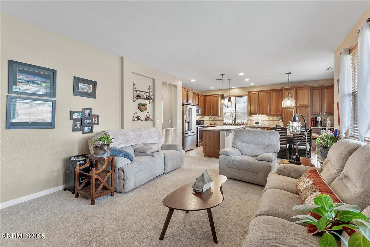 10755 Copper Lake Drive Reno, NV 89521 - Photo 7 of 40 a living room with furniture and a dining table with kitchen view
