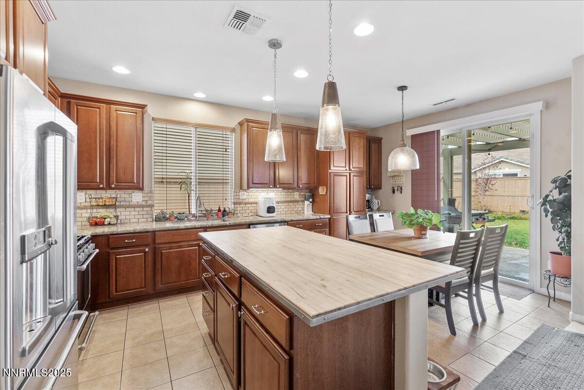 10755 Copper Lake Drive Reno, NV 89521 - Photo 9 of 40 a kitchen with granite countertop a sink a counter space appliances and cabinets