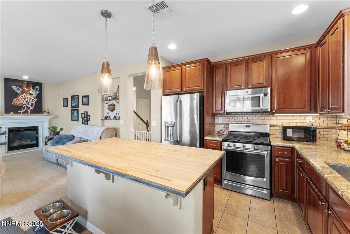 10755 Copper Lake Drive Reno, NV 89521 - Photo 10 of 40 a kitchen with a stove a sink and a refrigerator