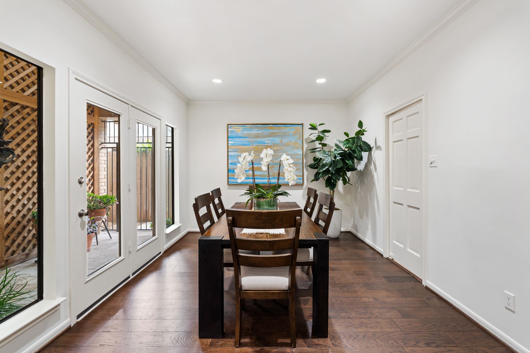 7416 Kelving Street Houston, TX 77030 - Photo 21 of 35 a dining room with furniture potted plants and wooden floor