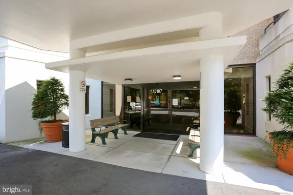 a lobby with furniture and potted plants
