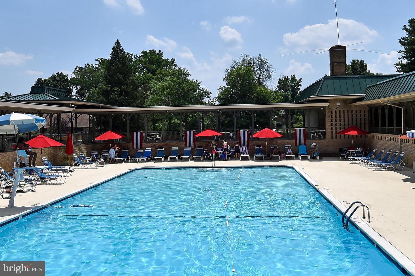 15107 Interlachen Drive, Unit 2815 Silver Spring, MD 20906 - Photo 18 of 35 Sunny poolside retreat with vibrant umbrellas.