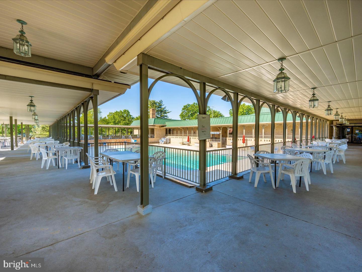 15107 Interlachen Drive, Unit 2815 Silver Spring, MD 20906 - Photo 31 of 35 Outdoor poolside retreat with shaded seating.