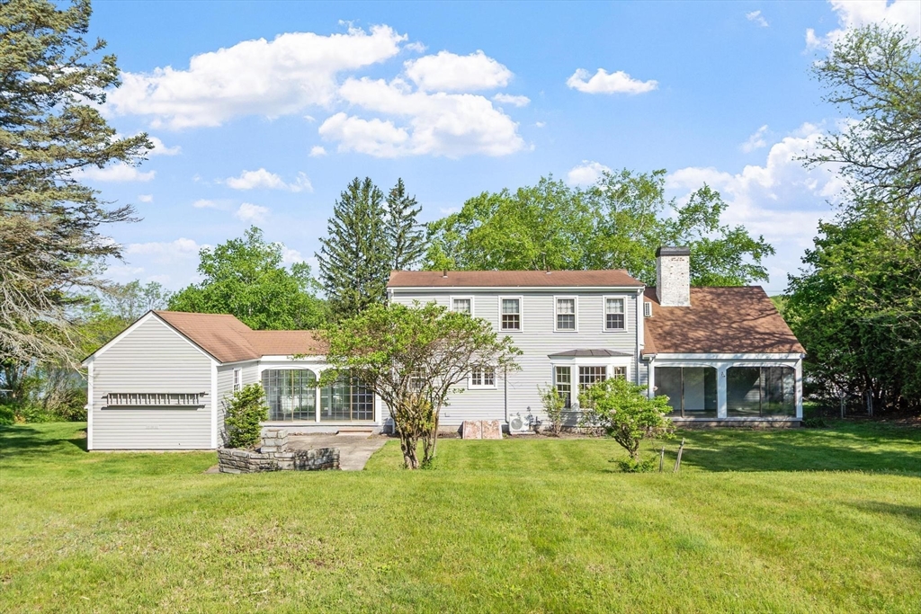 454 Wilson Street Clinton, MA 01510 - Photo 7 of 39 a front view of a house with a garden and yard