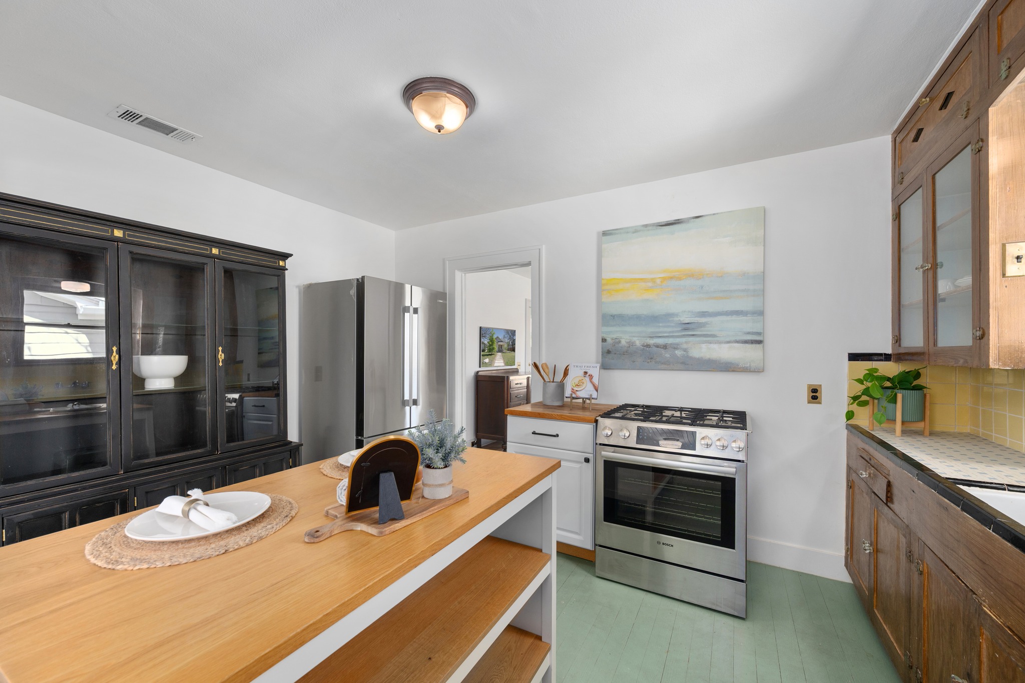3909 Becker Avenue Austin, TX 78751 - Photo 13 of 38 Kitchen featuring glass fronted cabinets, stainless steel appliances, and decorative backsplash