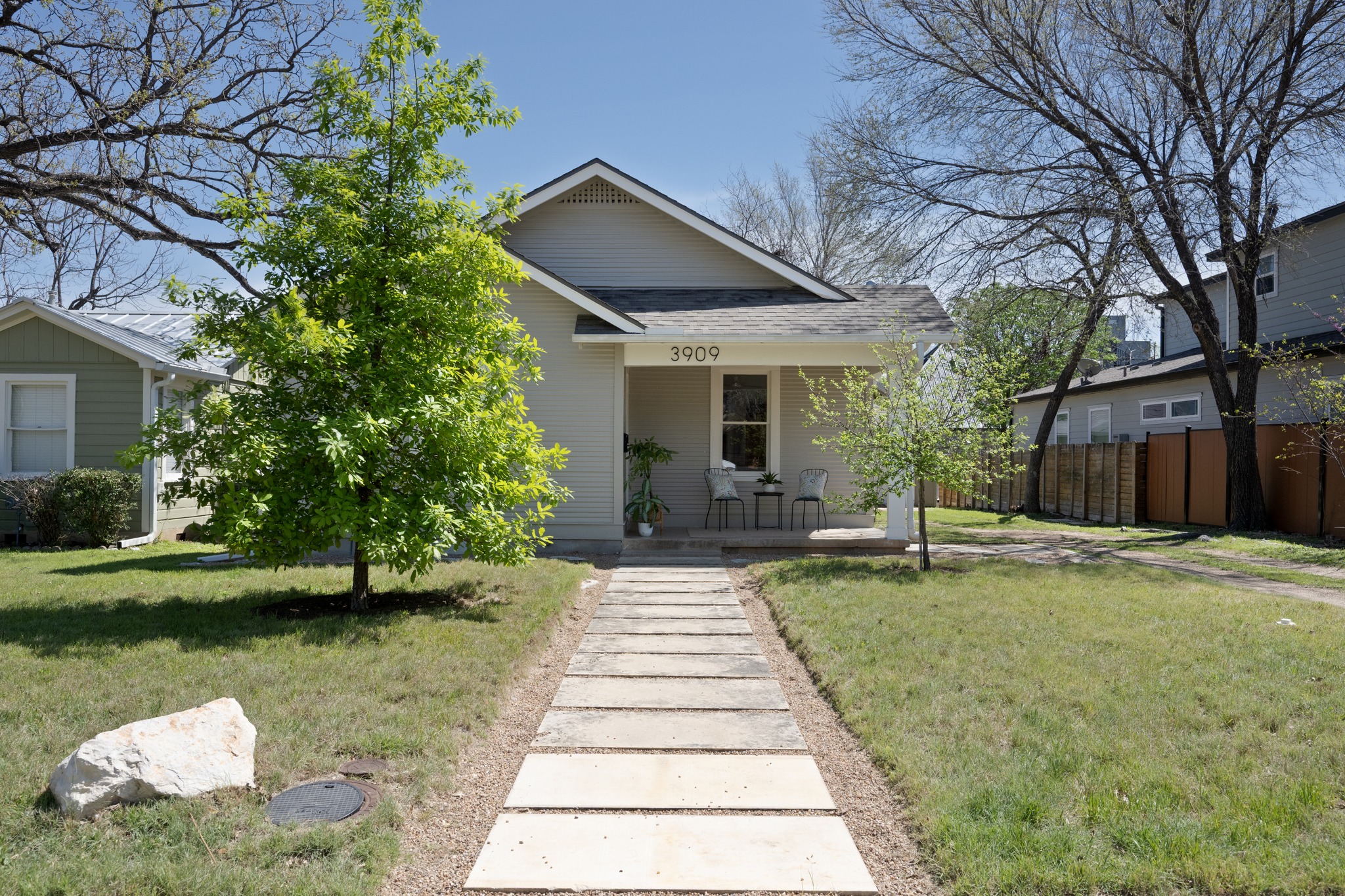 3909 Becker Avenue Austin, TX 78751 - Photo 2 of 38 View of front of property with covered porch, a front lawn, and roof with shingles