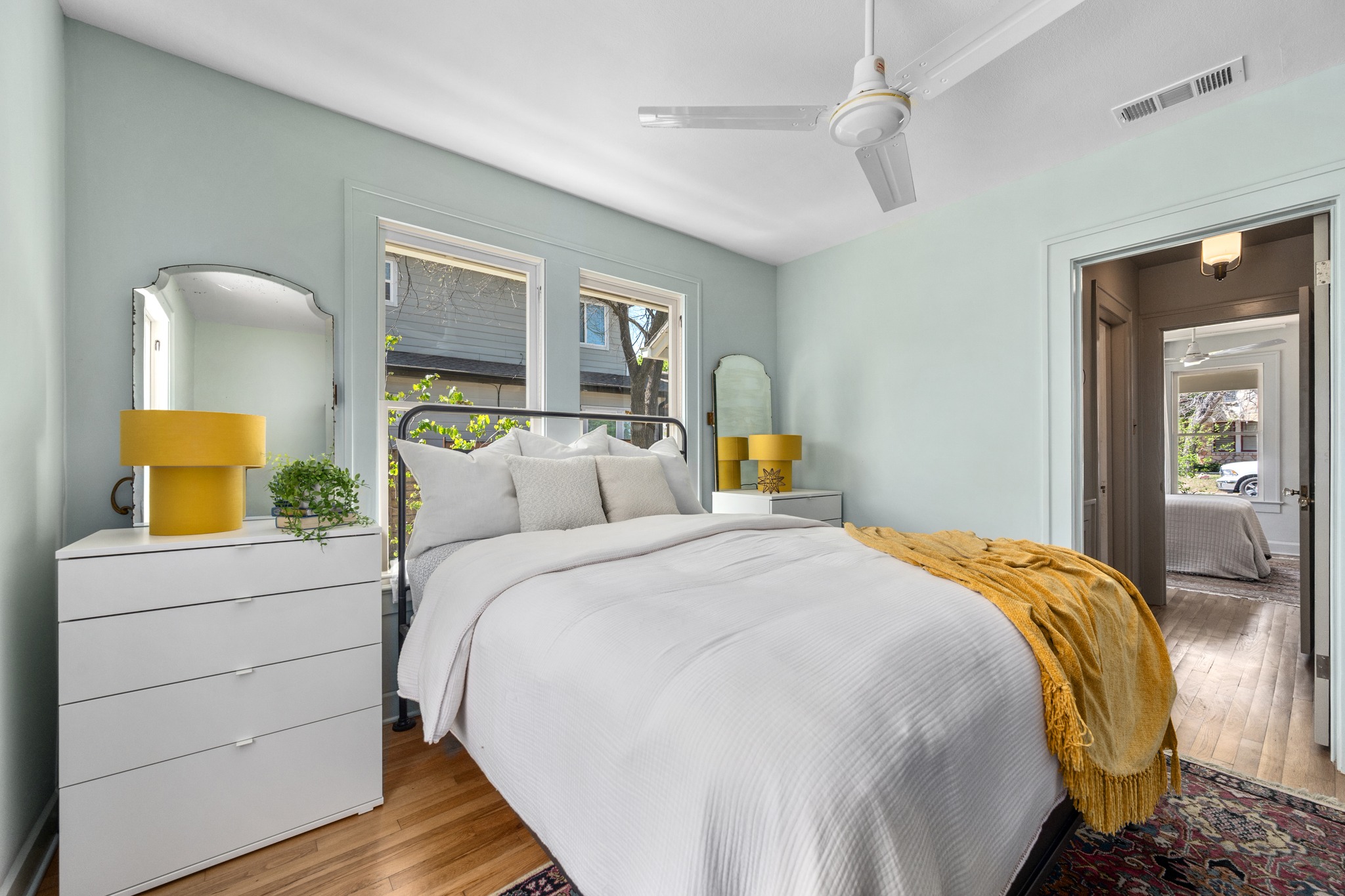 3909 Becker Avenue Austin, TX 78751 - Photo 22 of 38 Bedroom featuring wood finished floors, multiple windows, and ceiling fan