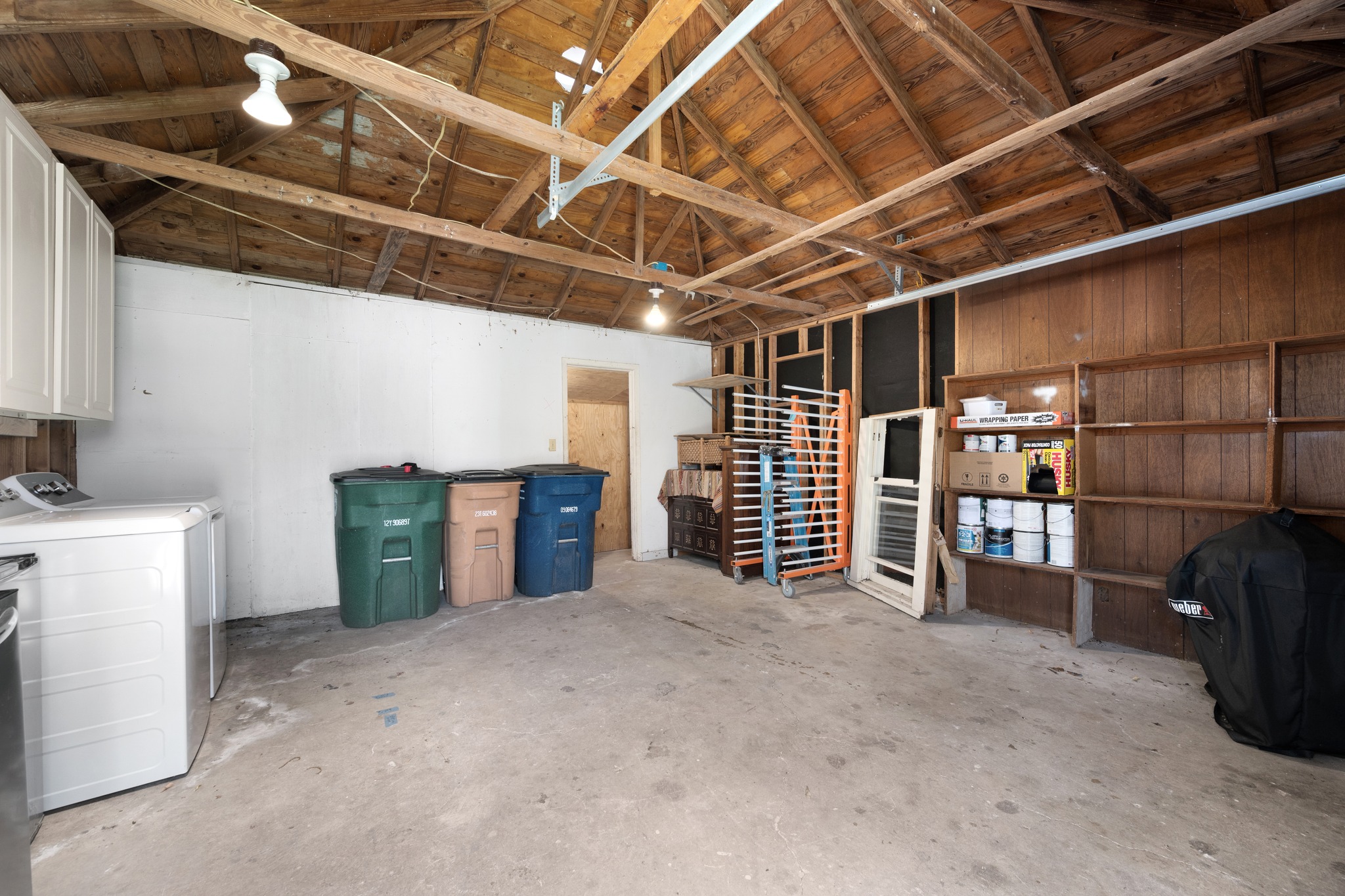3909 Becker Avenue Austin, TX 78751 - Photo 26 of 38 Garage featuring wooden ceiling and washing machine and clothes dryer