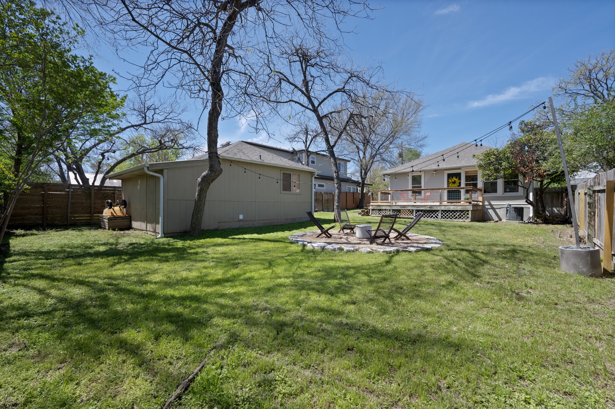 3909 Becker Avenue Austin, TX 78751 - Photo 29 of 38 Fenced backyard featuring a fire pit, a wooden deck, and a patio