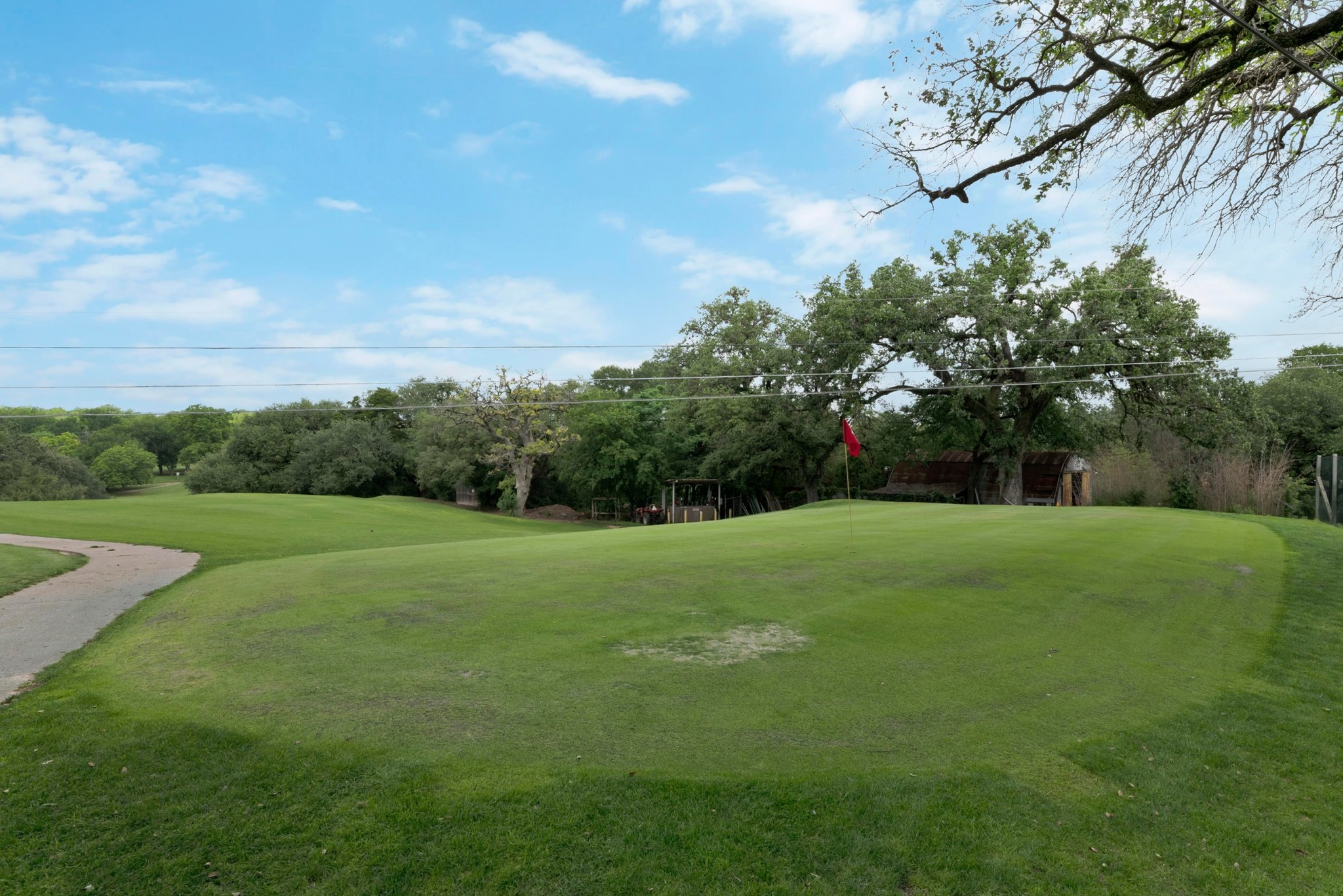 3909 Becker Avenue Austin, TX 78751 - Photo 33 of 38 View of green lawn with golf course view and view of wooded area