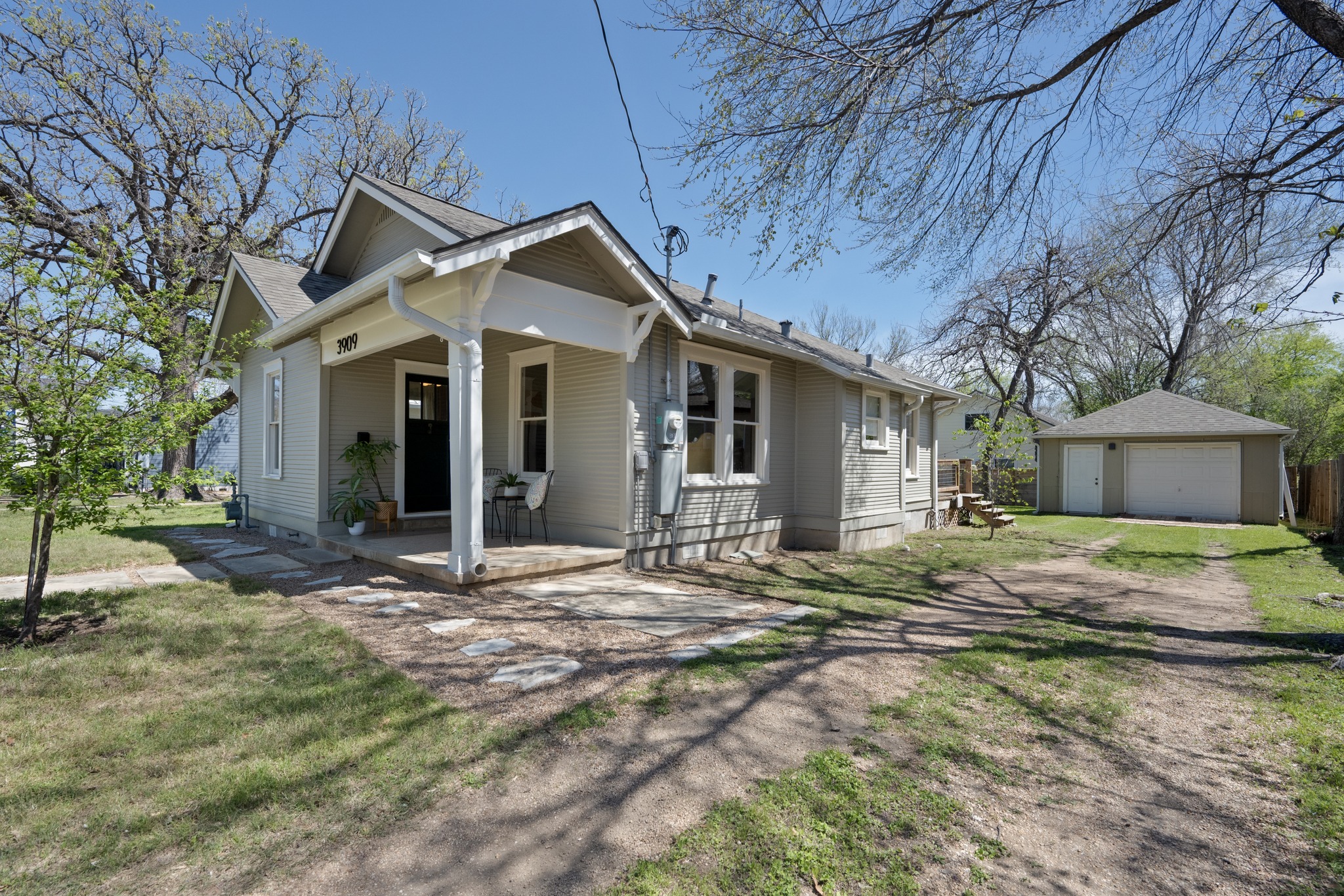 3909 Becker Avenue Austin, TX 78751 - Photo 6 of 38 Bungalow-style home featuring an outdoor structure, a garage, driveway, a porch, and a front yard