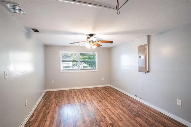 wooden floor in an empty room with a window
