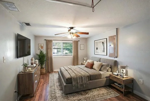 a bedroom with a bed and a chandelier