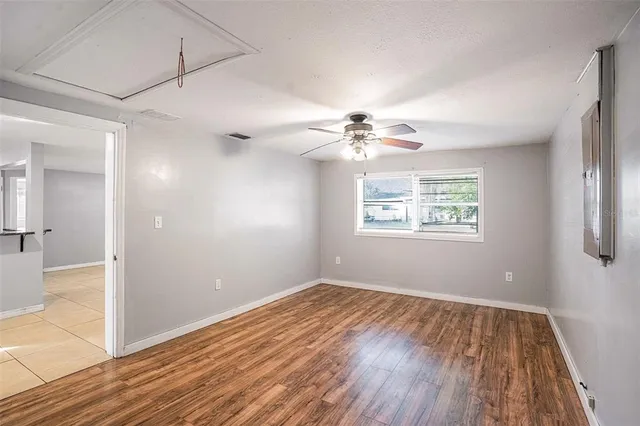 wooden floor in an empty room with a window
