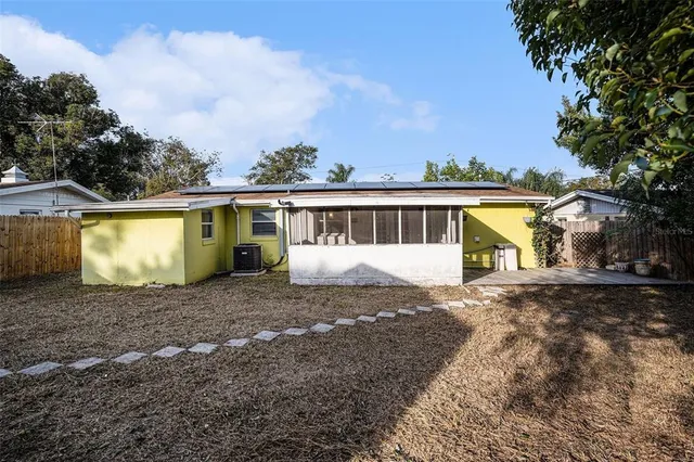 a view of a house with a yard and a garage