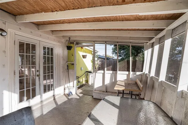 a living room with furniture and a large window with garden view