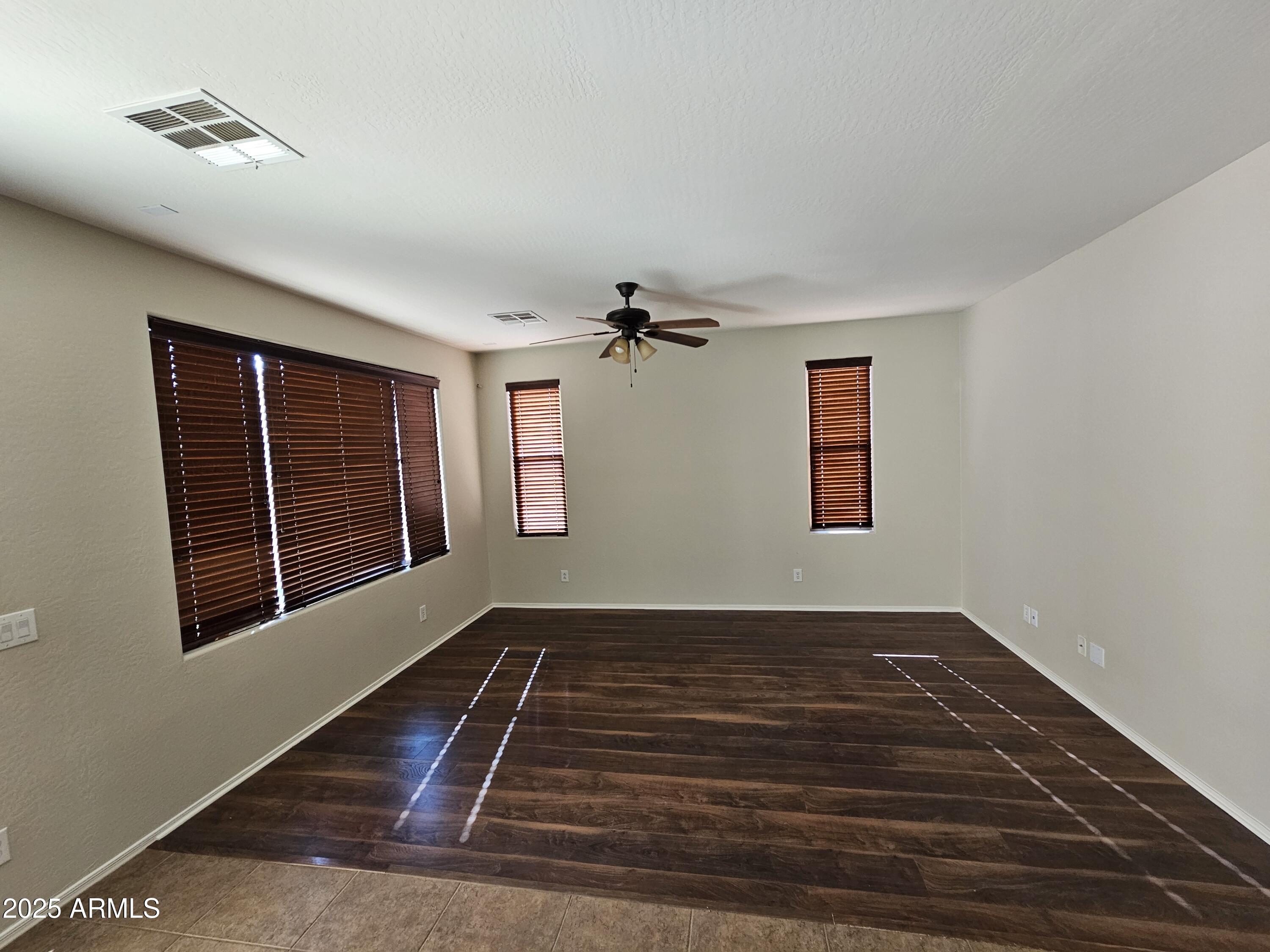 1867 South Seton Avenue Gilbert, AZ 85295 - Photo 4 of 8 a view of an empty room with wooden floor and a window