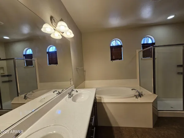a bathroom with a sink a large mirror and a bathtub