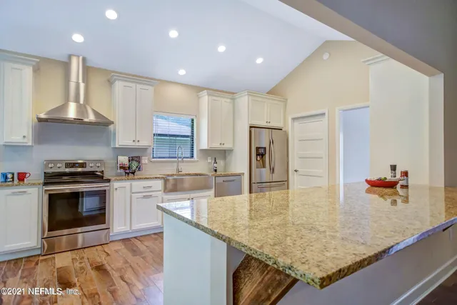 a kitchen with stainless steel appliances granite countertop a sink counter space and cabinets