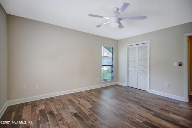 wooden floor in an empty room with a window