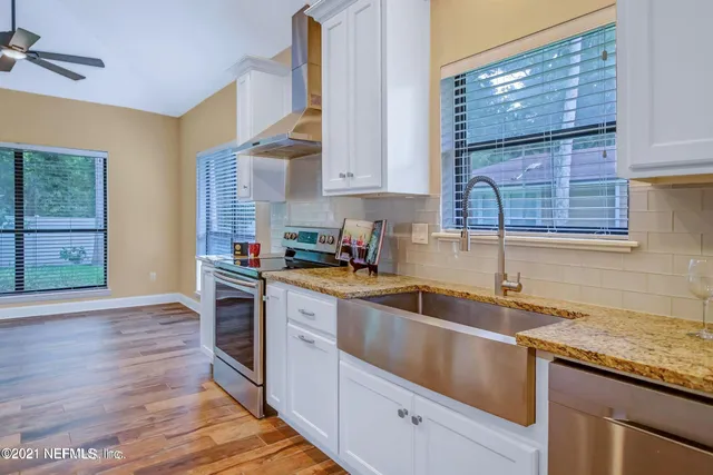 a kitchen with a sink cabinets and window