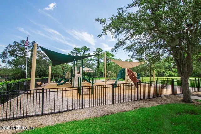 a view of a white house in the back yard