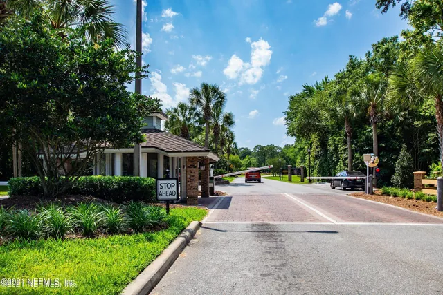 a front view of a house with yard and green space