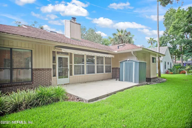 a view of a house with a yard and a garden