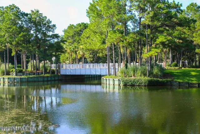 a view of a lake with houses in the background