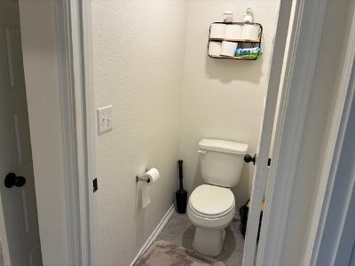 221 Summit Drive Lockhart, TX 78644 - Photo 13 of 16 a white toilet sitting next to a bathroom sink