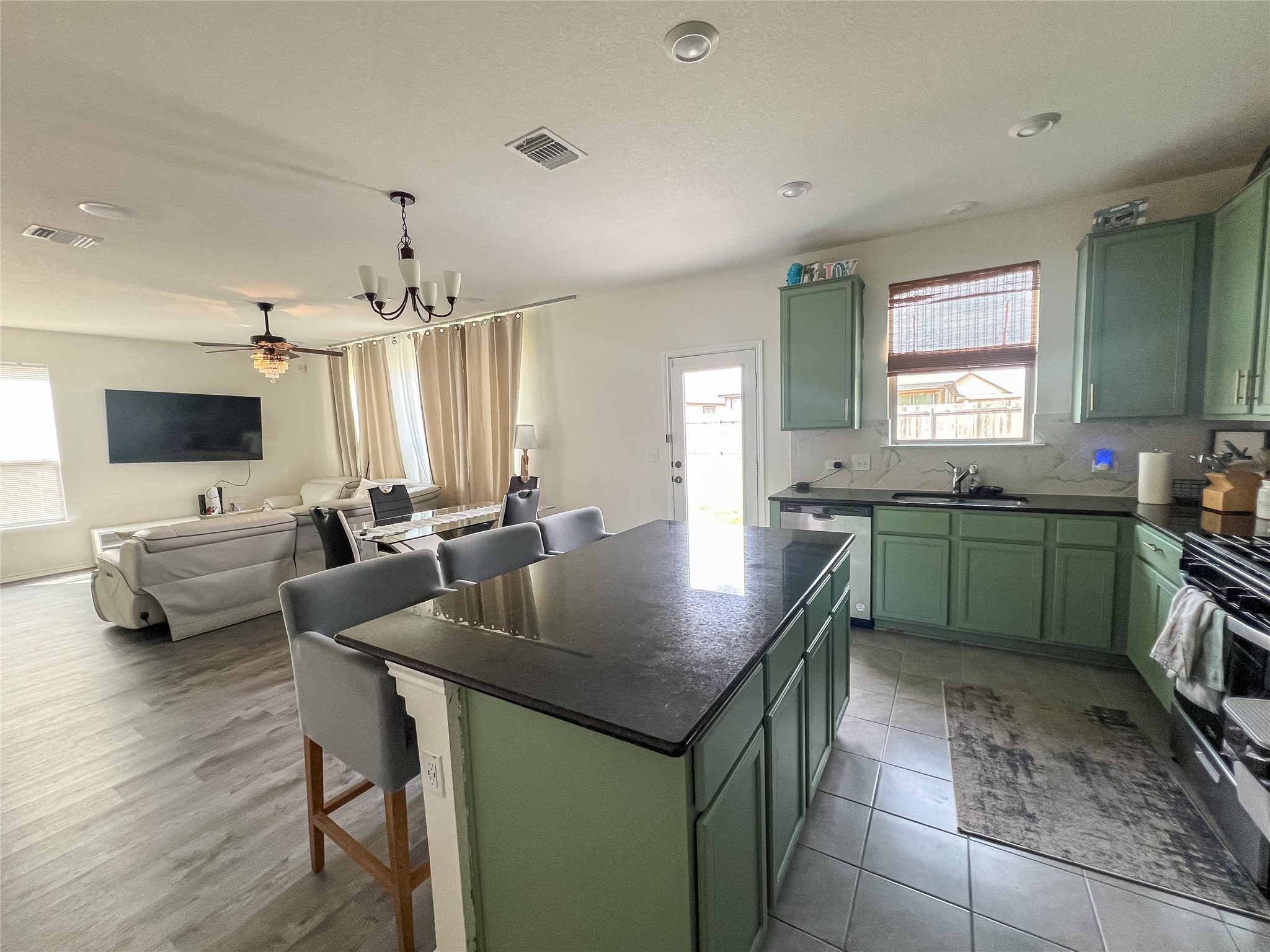 221 Summit Drive Lockhart, TX 78644 - Photo 4 of 16 a kitchen with a table chairs sink and microwave