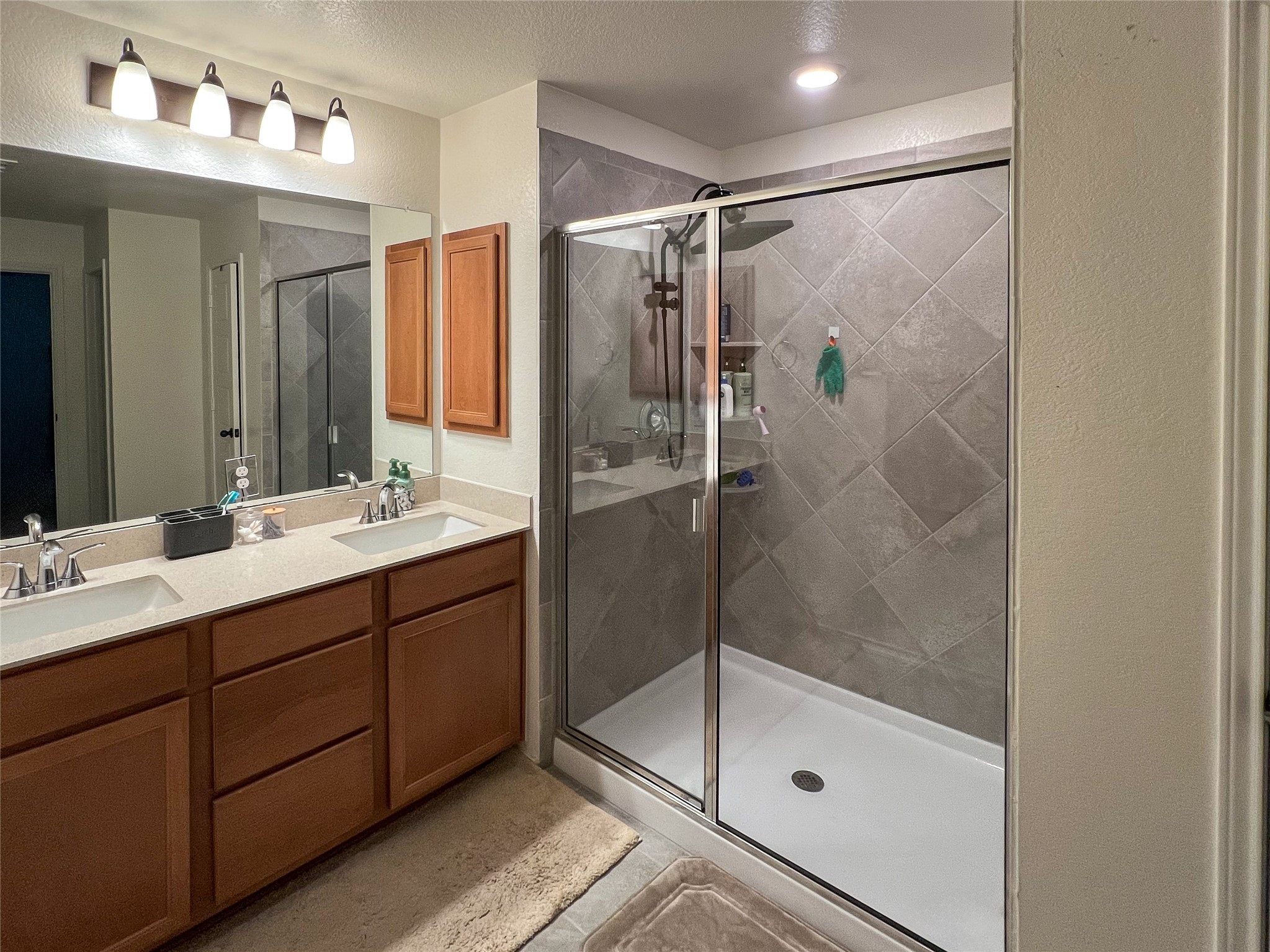 221 Summit Drive Lockhart, TX 78644 - Photo 7 of 16 a bathroom with a shower sink and mirror