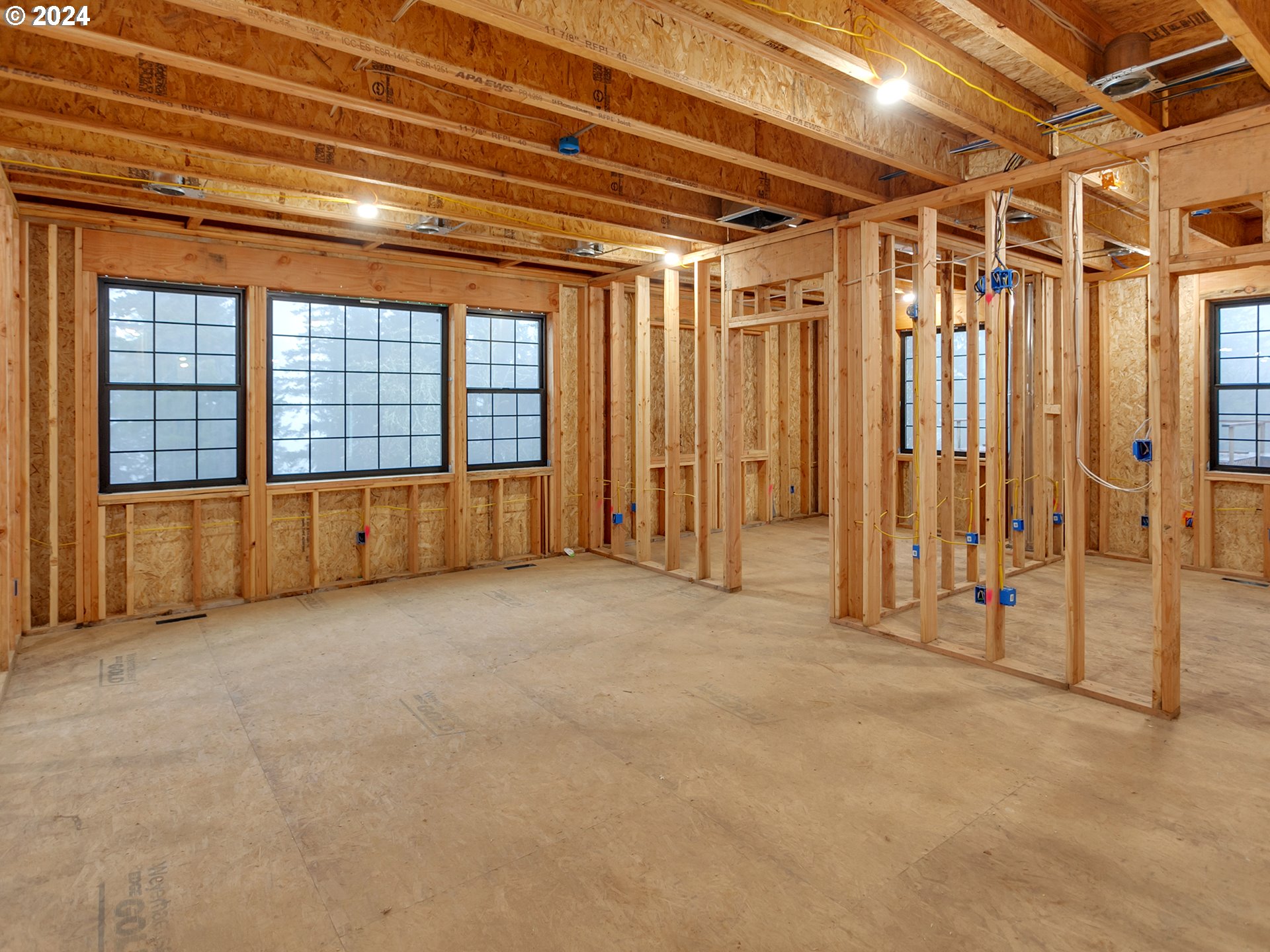 27778 Briggs Hill Road Eugene, OR 97405 - Photo 6 of 25 a view of an empty room with wooden walls and a window