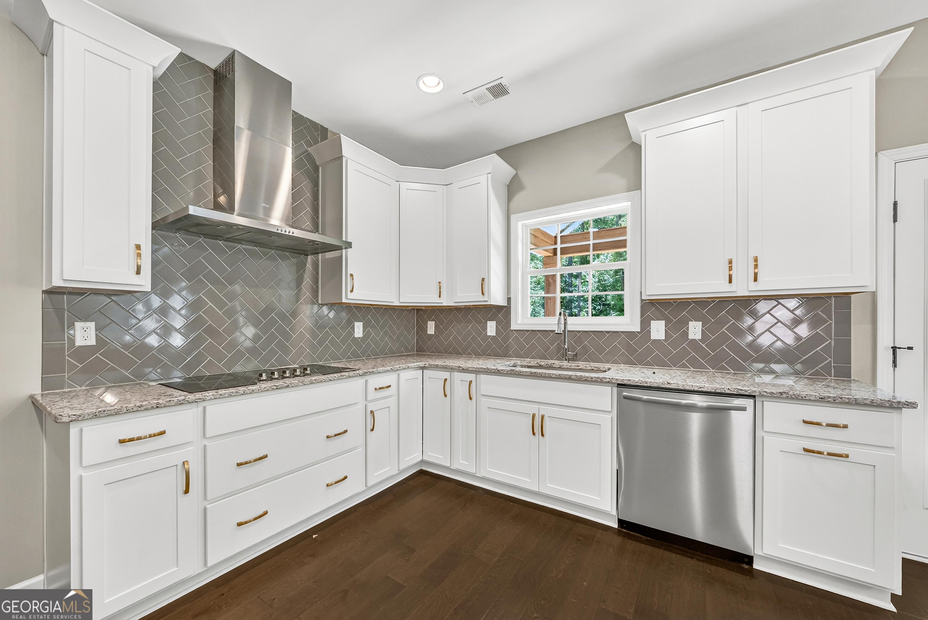 38 Oak Ridge Drive, Unit 26 Waverly Hall, GA 31831 - Photo 15 of 37 a kitchen with granite countertop white cabinets and white appliances