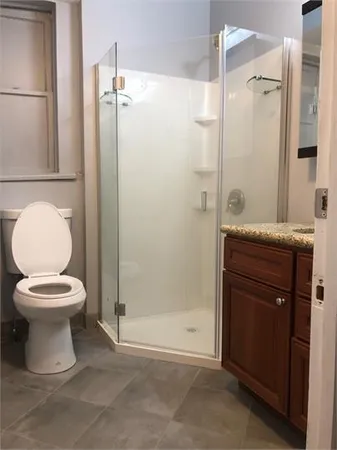 a bathroom with a toilet sink and shower