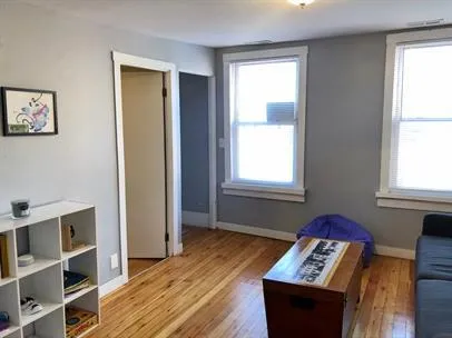 a view of room with wooden floor and windows