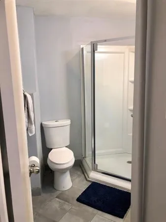 a bathroom with a toilet and a shower