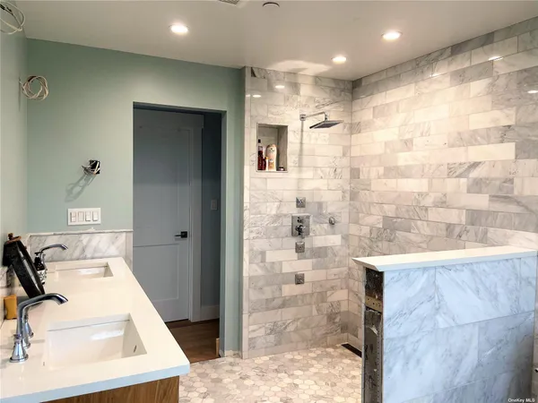 a bathroom with a bathtub sink and mirror