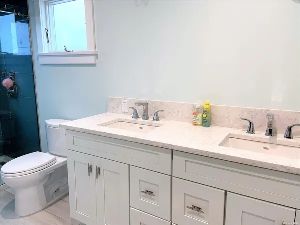 a bathroom with a sink toilet and a mirror